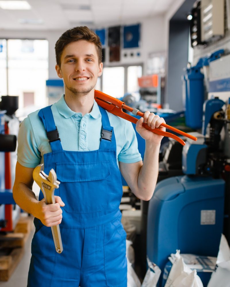 plumber-shows-pipe-wrenches-in-plumbering-store.jpg